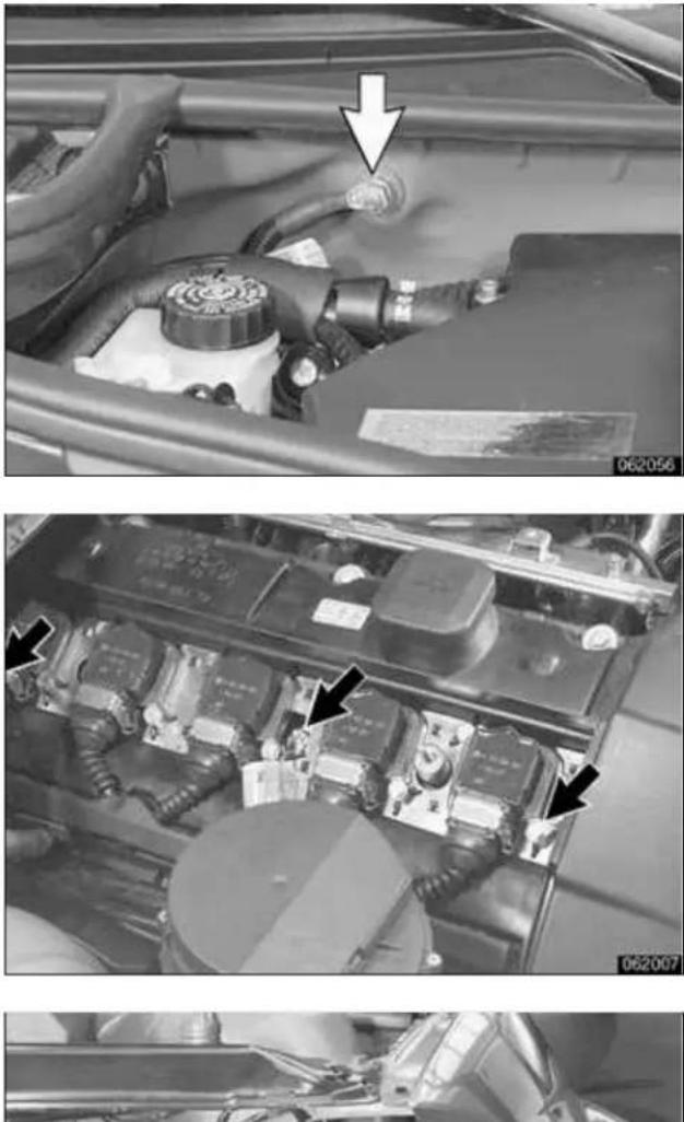 Close-up of a car engine bay with visible components and wiring, showing structural details (no text or symbols)