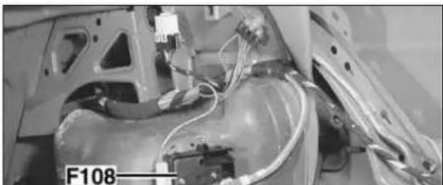 Close-up of a car chassis with visible wiring and components, no readable text or symbols