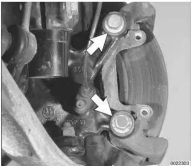 Close-up mechanical assembly with white arrows pointing to specific components (no visible text or symbols)