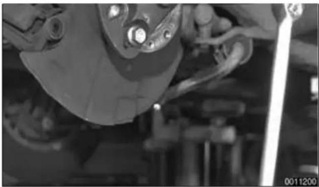 Close-up of a car brake system with visible suspension components and no text or symbols