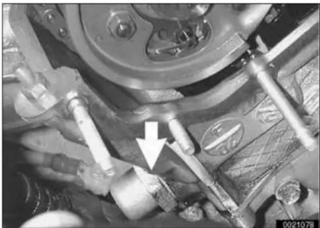 Close-up mechanical assembly with pipes and bolts, no visible text or symbols