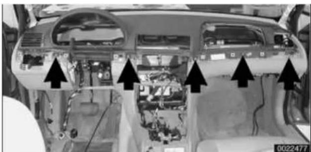 Interior view of a car dashboard with visible wiring, switches, and control panels (no text or symbols)