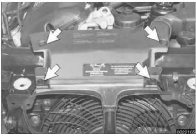 Top-down view of a car engine head with visible structural components and mounting brackets (no text or symbols)