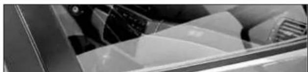 Close-up of a mechanical component with curved surfaces and a metallic bracket (no visible text or symbols)