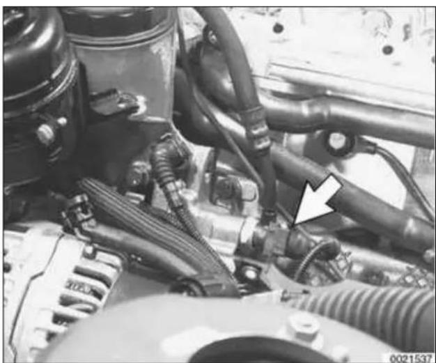 Close-up of an automotive engine bay with visible hoses and components, no text or symbols present