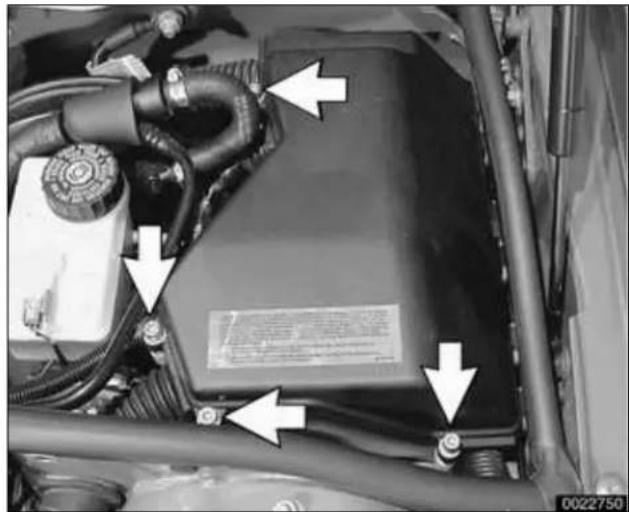Close-up of a car engine bay with visible wiring and mounting brackets (no text or symbols)