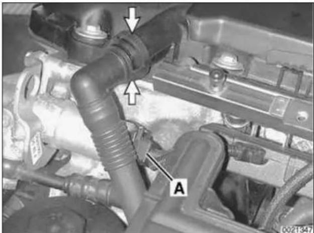 Close-up of an engine cylinder assembly with labeled parts (A and arrows), no readable text or symbols beyond labels