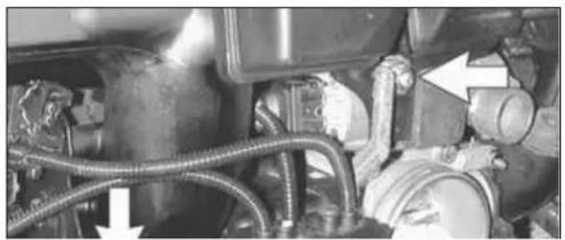 Close-up of mechanical components with hoses and connectors, no visible text or symbols