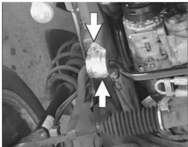 Close-up of a mechanical assembly with visible hoses and components, no text or symbols present