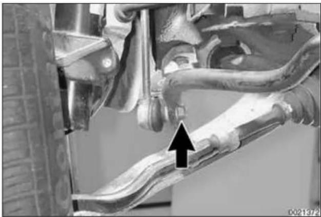 Close-up of a car suspension system with visible mechanical components and a black arrow indicating a specific component (no text or symbols present)