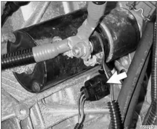 Close-up of automotive suspension system components with hoses and wiring (no visible text or symbols)