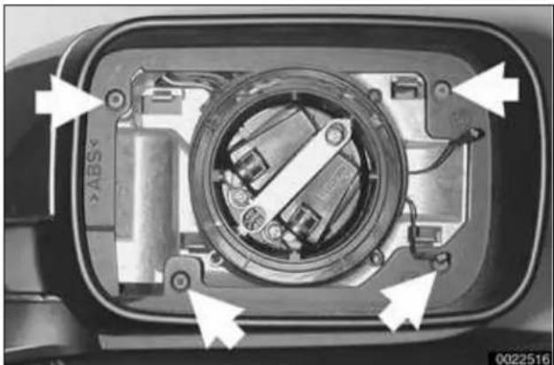 Close-up of a mechanical component with internal components and directional arrows indicating assembly (no text or symbols)