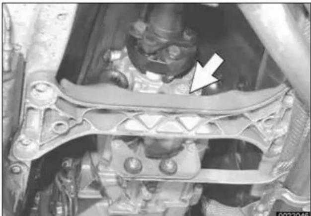 Close-up of a mechanical assembly with a white arrow pointing to a component (no visible text or symbols)