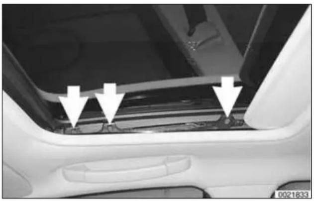 Close-up of a car's front panel showing three white arrows pointing to the side panel (no text or symbols visible)