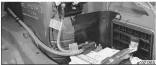 Close-up of a vehicle battery pack with attached wiring and a door panel (no visible text or symbols)