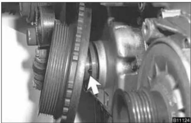 Close-up of mechanical components with a white arrow pointing to a specific part (no visible text or symbols)