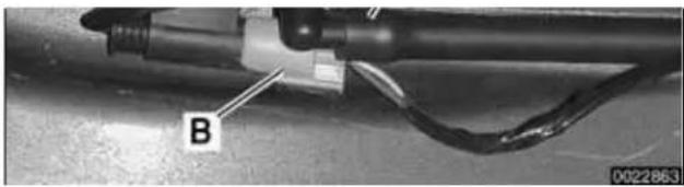 Close-up of a mechanical component with labeled part B, no visible text or symbols beyond label