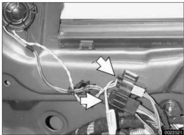 Close-up of a car engine component with wiring and connectors (no visible text or symbols)