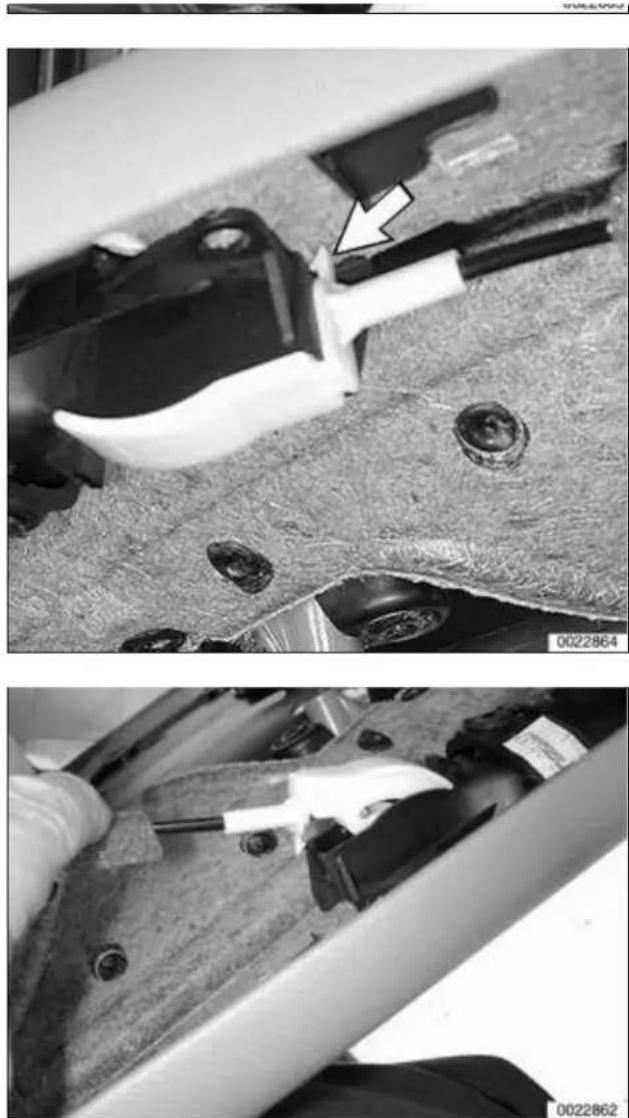 Close-up of mechanical components with a white tool inserted, showing part damage and assembly (no visible text or symbols)