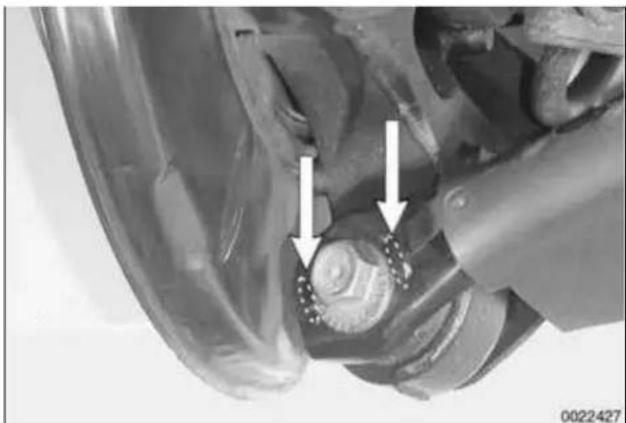 Close-up of a mechanical assembly with two white arrows pointing to a component, no visible text or symbols.