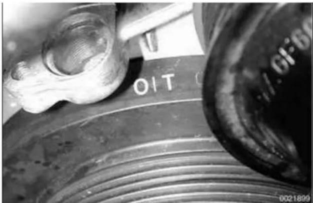Close-up of a mechanical component with threaded surface and labeled part 'O/T', no readable text or symbols beyond the label
