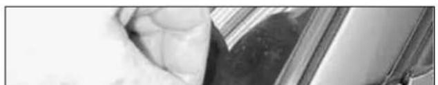Close-up of a textured surface with dark and light regions, possibly fabric or material (no visible text or symbols)