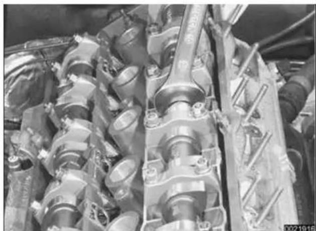 Close-up of industrial engine components with visible pipes and springs (no text or symbols)