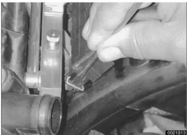 Close-up of a hand adjusting a mechanical component with a small attached part (no visible text or symbols)