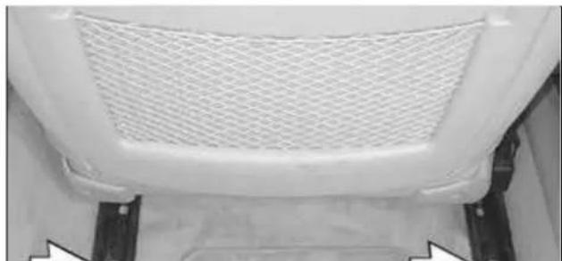 Close-up of a white car's side panel with mesh grille and mounting brackets (no text or symbols visible)