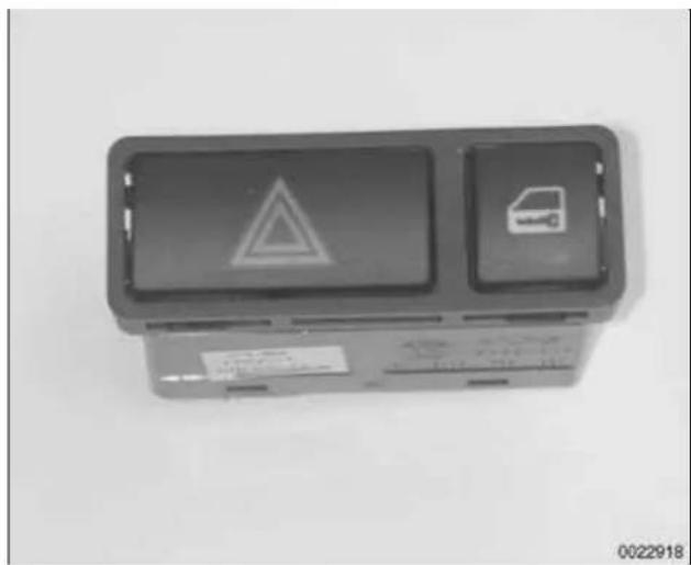 Exterior view of a rectangular electronic device with two display panels and warning symbols (no readable text or labels)
