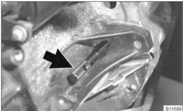 Close-up of mechanical components with a black arrow pointing to a specific part (no visible text or symbols)