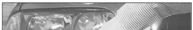 Close-up of a car's front wheel and side window with visible mechanical components (no text or symbols)