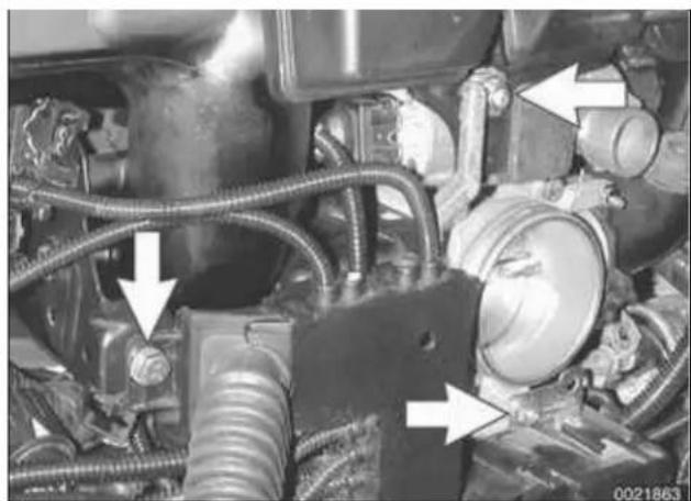 Close-up of an automotive engine bay with hoses and components, no visible text or symbols