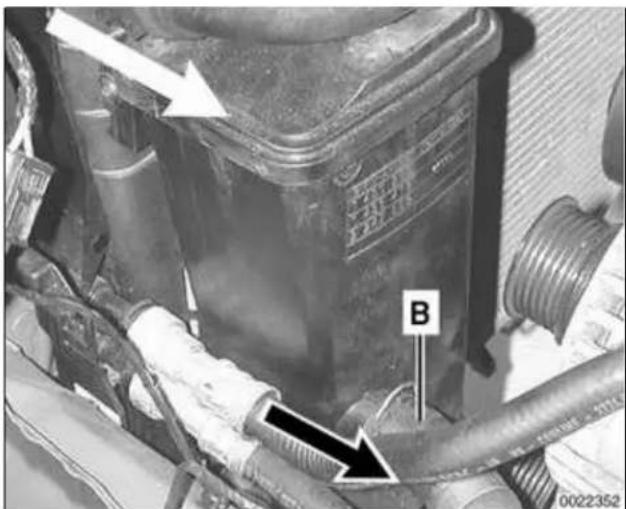Technical diagram of an engine component with labeled parts and directional arrows indicating assembly or inspection.