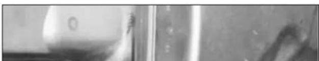 Close-up of a metallic surface with reflective surfaces and minor debris (no text or symbols visible)