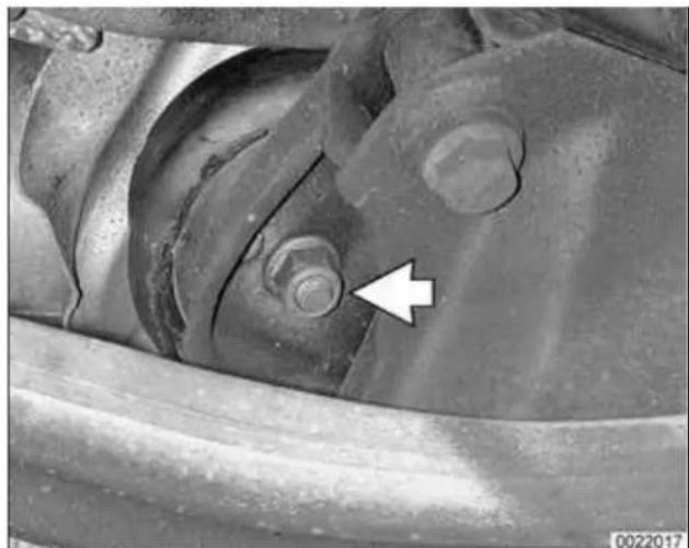 Close-up of a mechanical component with a white arrow pointing to a bolt detail (no text or symbols visible)