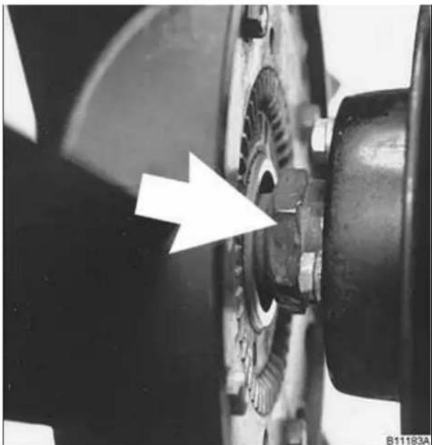 Close-up of mechanical components with a white arrow pointing to a specific part (no visible text or symbols)