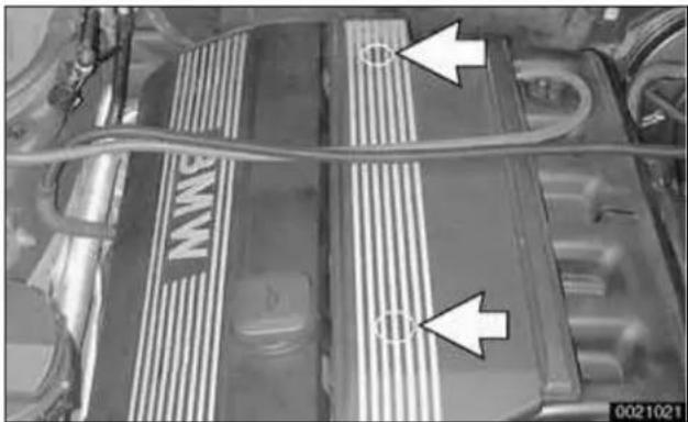 Close-up of a car battery pack with visible circuit lines and two white arrows pointing to specific sections (no text or symbols)