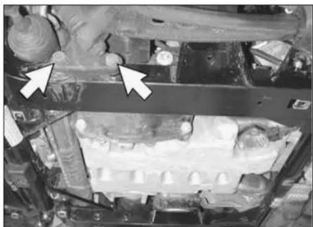 Close-up of a mechanical component with two white arrows pointing to specific parts (no visible text or symbols)