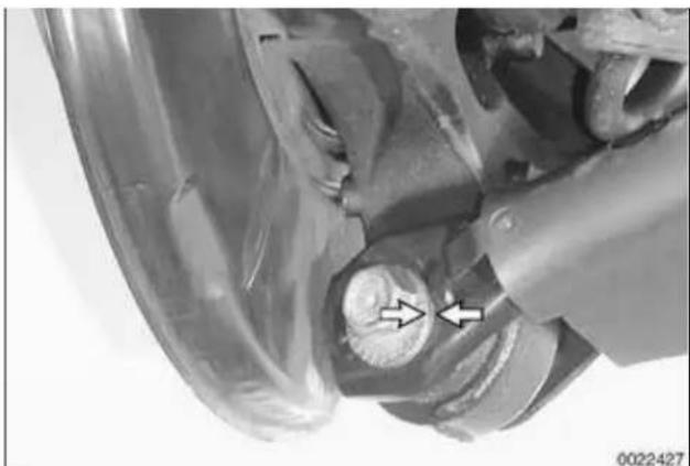 Close-up of a mechanical component with arrows pointing to a circular feature (no visible text or symbols)