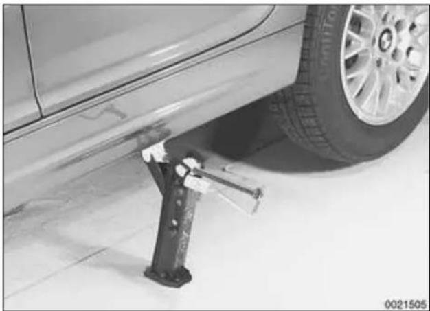 Close-up of a car tire mounted on a floor next to a mechanical clamp (no visible text or symbols)