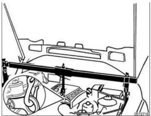 Interior view of a vehicle dashboard with steering wheel and dashboard, showing engine compartment and gear assembly (no text or symbols)