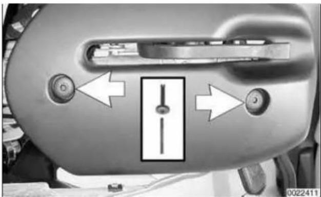Close-up of a mechanical component with two circular buttons and a central vertical slider, no visible text or symbols.