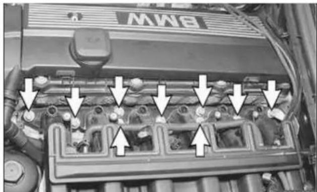 Engine bay with multiple engine components and directional arrows indicating flow or movement (no readable text or symbols)