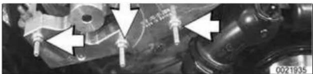 Close-up of mechanical components with white arrows pointing to features (no readable text or symbols)