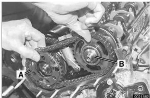 Close-up of hands assembling a mechanical component with labeled parts A and B (no readable text or symbols beyond labels)