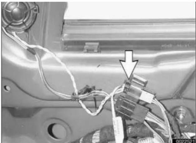 Close-up of a car interior with wires and connectors, no visible text or symbols
