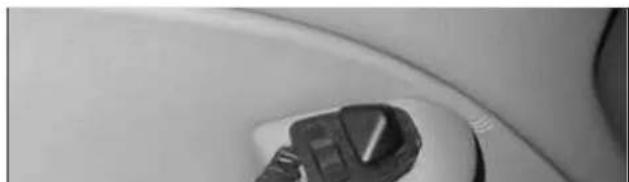 Close-up of a car's seatbelt with a handbag (no visible text or symbols)