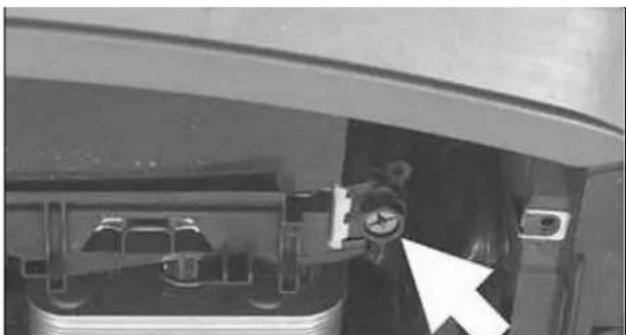 Interior view of a vehicle showing a pressure gauge mounted on the hood, with no visible text or symbols.