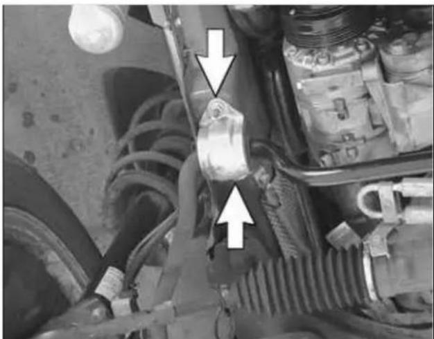 Close-up of a mechanical assembly with visible springs and hoses, no text or symbols present